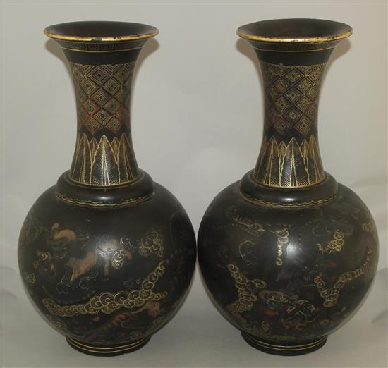 A pair of Chinese gilt and polychrome decorated black lacquer bottle vases, early 20th century, 44cm